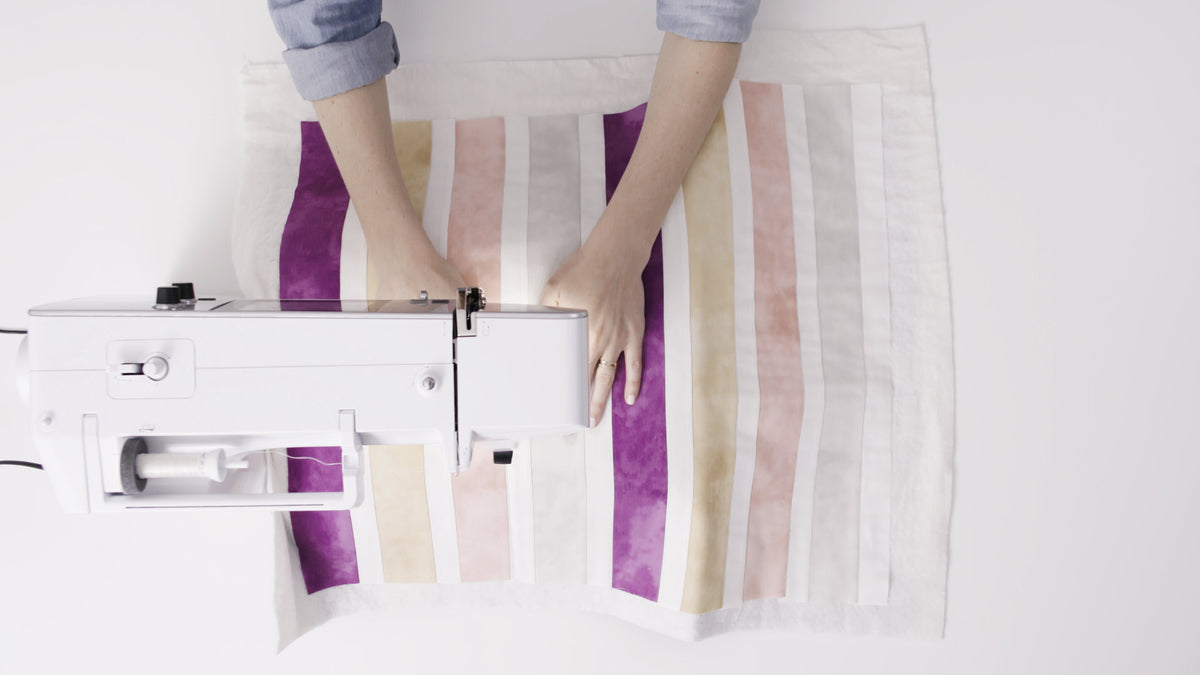 BERNINA 570 QE - overhead view sewing a striped fabric project