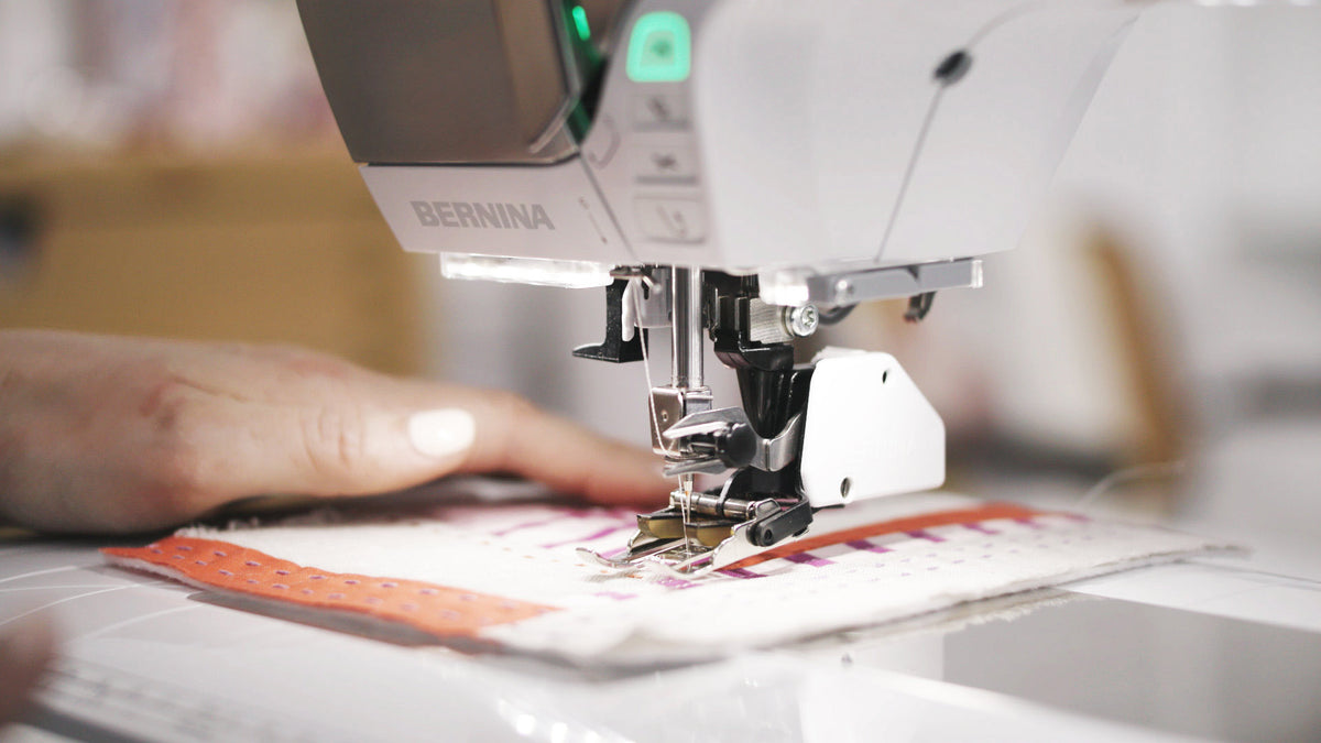 BERNINA 570 QE - needle, presser foot and Dual Feed sewing layered fabric close-up