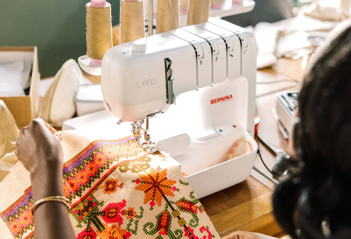 BERNINA L660 Serger three-quarter view while overlocking fabric