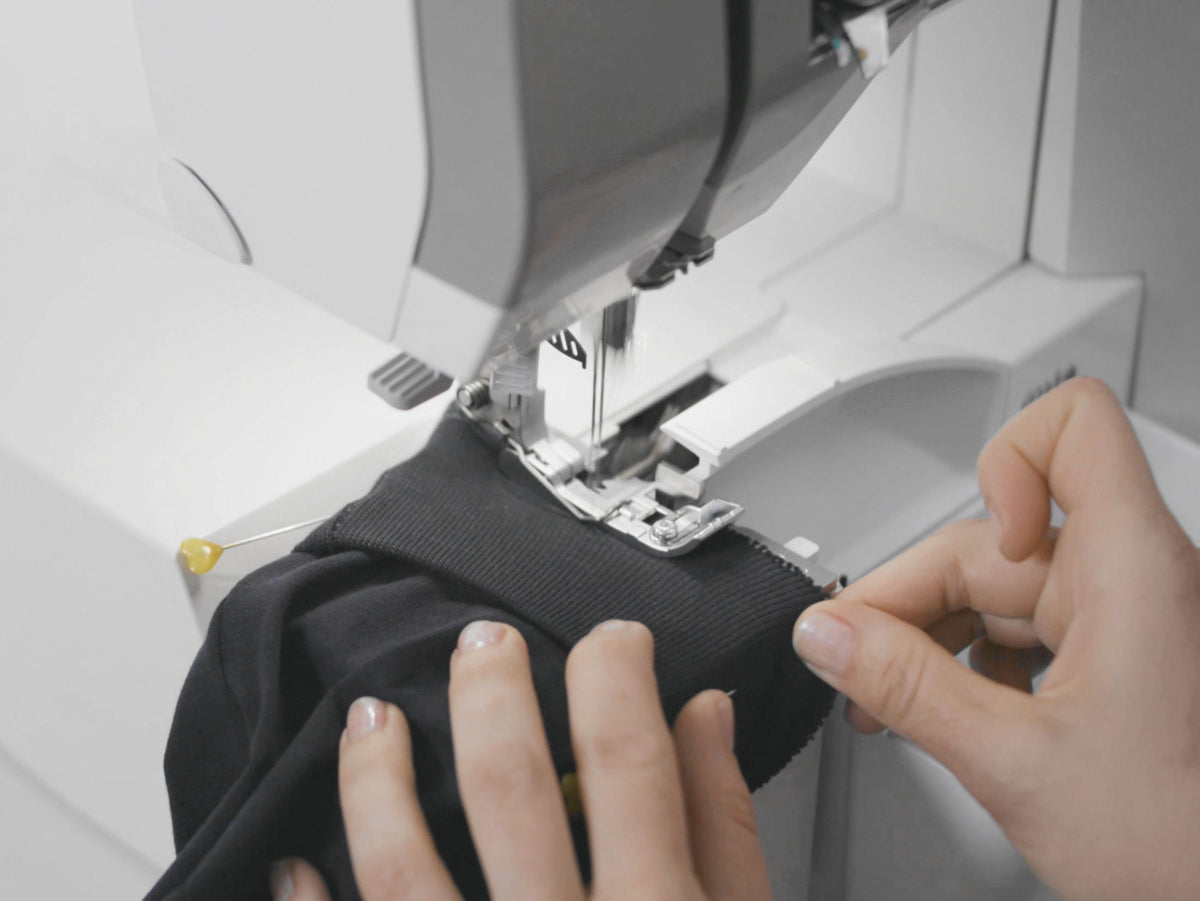 BERNINA L850 Serger close-up of needle and presser-foot area while overlocking fabric