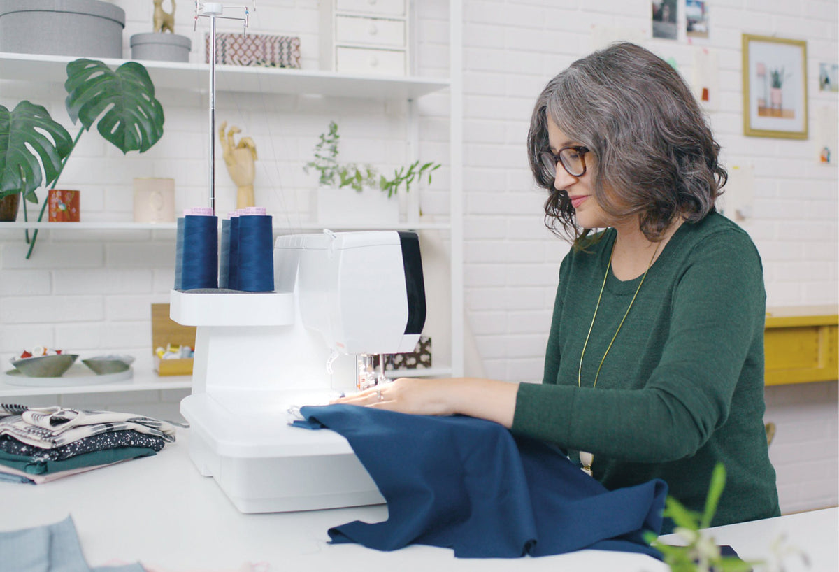 BERNINA L890 Overlock/Coverstitch Machine rear three-quarter view while overlocking fabric